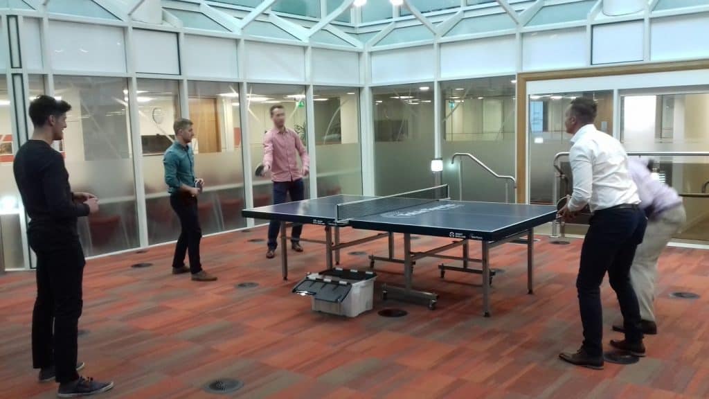 Males playing table tennis during break